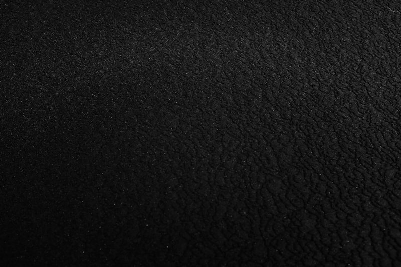 Dark luxury marble texture, highly detailed stone surface, premium organic background, warm mahogany lighting, no people